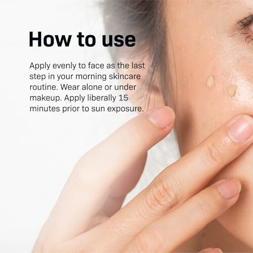 Person applying skincare product to face with instructions.