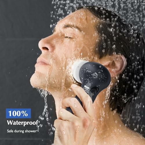 Person using waterproof electric shaver in shower.