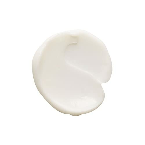 Close-up of white cream texture on a plain background.